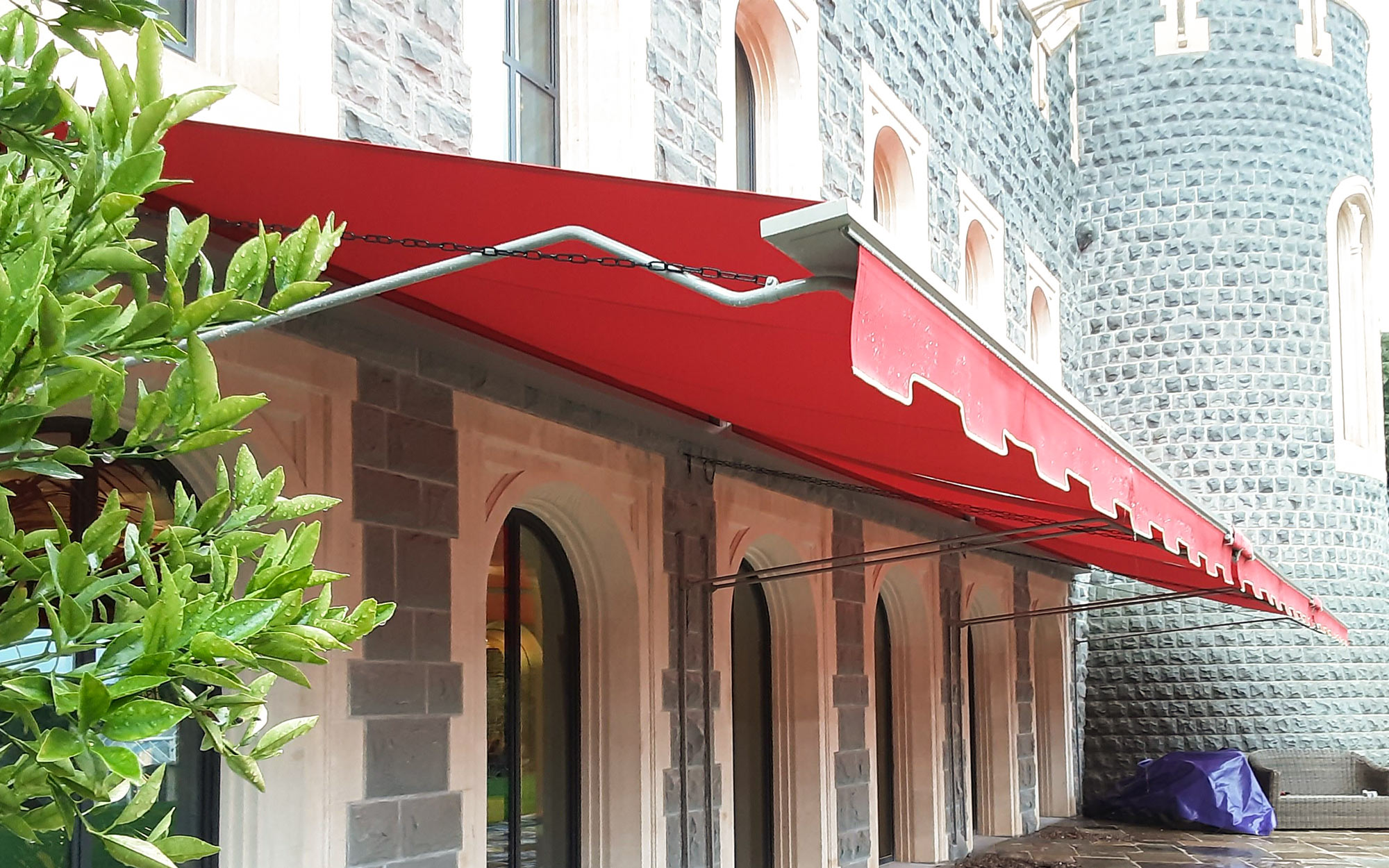 Red awning fabric with castellated valances by Morco